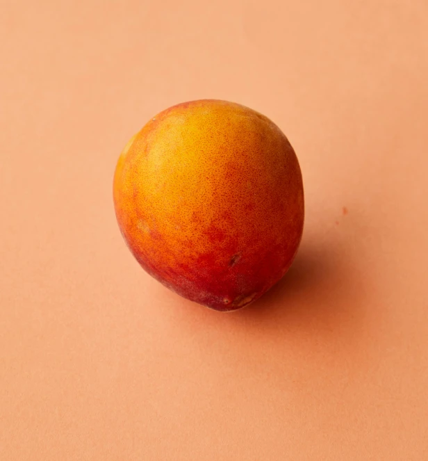 a peach sitting on top of a pink surface, jungle fruit, zoomed out to show entire image, light tan, vanilla