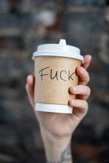 a person holding a cup of coffee with the word fuck written on it, by Tracey Emin, trending on pexels, stuckism, heavily upvoted, sam hyde, coffee cup, annoyed