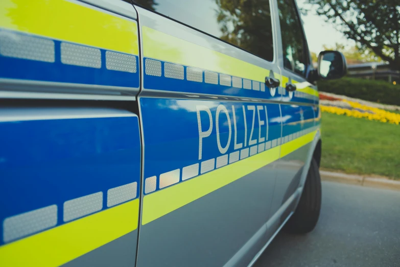 a police car parked on the side of the road, by Thomas Häfner, pexels, 2 5 6 x 2 5 6 pixels, lower saxony, medium closeup, dof wide