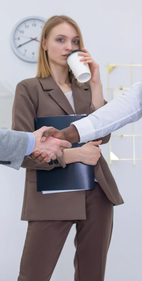 a group of business people shaking hands, pexels contest winner, girl in suit, official screenshot, holding arms on holsters, chromatic