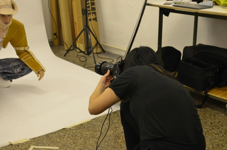 a woman that is kneeling down with a camera, cardboard, behind the scenes photography, italian renaissance workshop, professional photo-n 3
