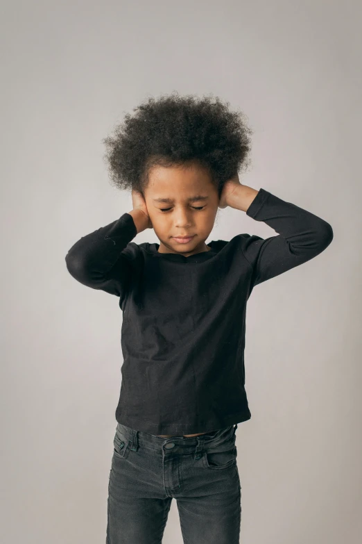 a little boy standing with his hands on his head, an album cover, by Nina Hamnett, pexels contest winner, symbolism, afro hair, wearing black clothes, thoughtful ), tinnitus