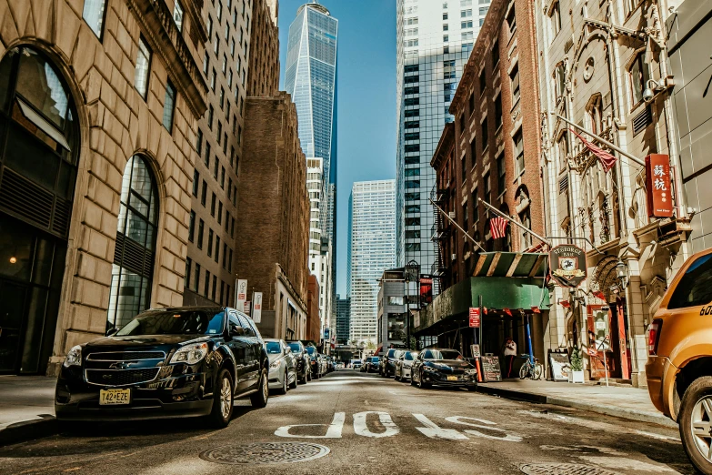 a city street filled with lots of tall buildings, by Carey Morris, pexels contest winner, cars parked underneath, new york back street, on a sunny day, background image