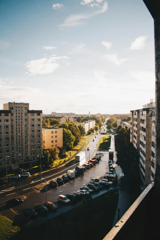 a view of a city from a window of a building, unsplash contest winner, socialist realism, capital of estonia, low quality photo, sunny sky, late summer evening