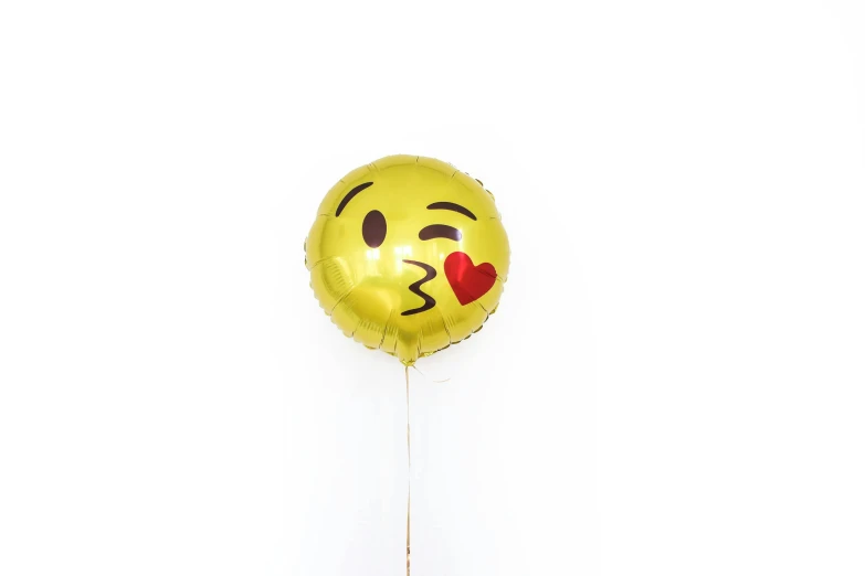 a person holding a balloon with a smiley face on it, gold foil, lovely kiss, set against a white background, pouting