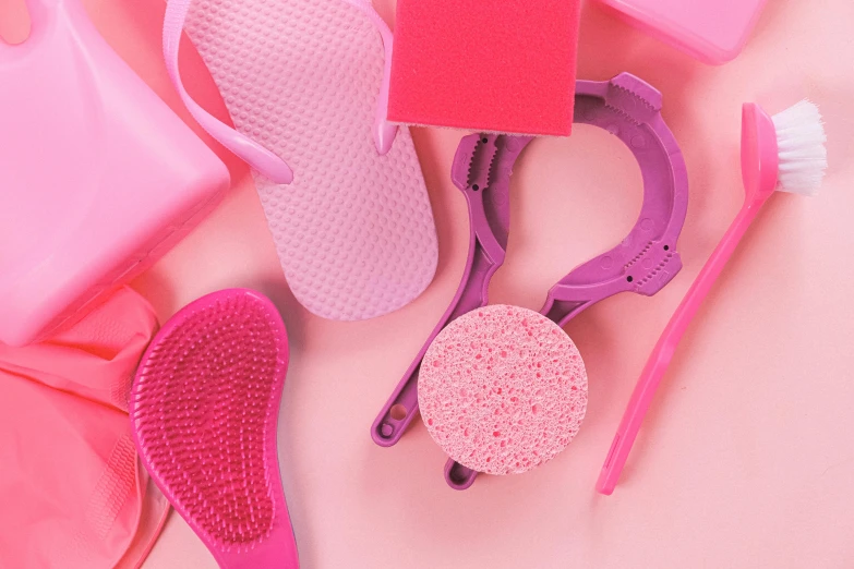 a variety of cleaning supplies laid out on a pink surface, a picture, trending on pexels, plasticien, silicone skin, wet brush, thumbnail, pink arches