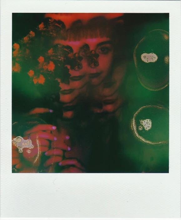 a close up of a person holding a camera, a polaroid photo, inspired by Elsa Bleda, holography, emma watson as poison ivy, translucent neon, scanned in, green aura