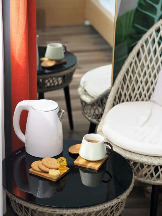 a table with a cup of coffee and cookies on it, kettle, 4l, sleek white, jakarta