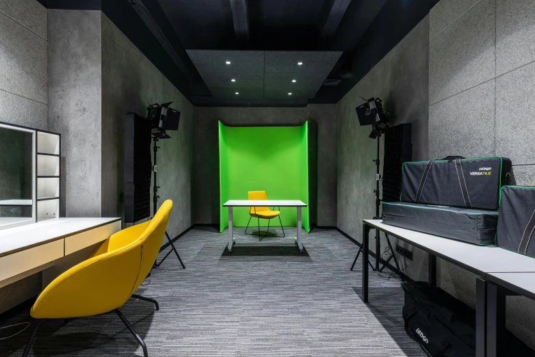 a green screen in the middle of a room, inspired by Jan Kupecký, unsplash, dark grey backdrop studio, yellow and green scheme, set inside of office, 3d models