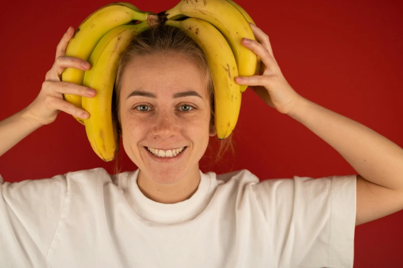 a woman with a bunch of bananas on her head, pexels contest winner, white cheeks, lachlan bailey, avatar image, yellow and red