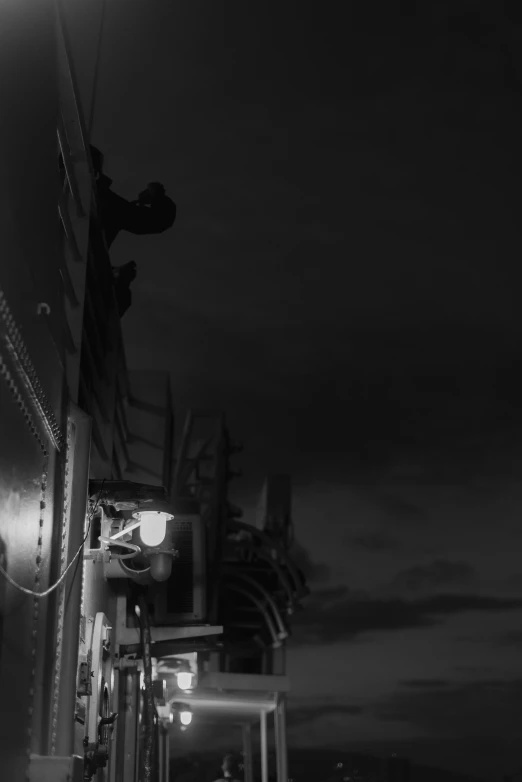 a black and white photo of a street at night, a black and white photo, inspired by Germaine Krull, unsplash, realism, standing on ship deck, a firetruck at night, low detail, ( ( photograph ) )