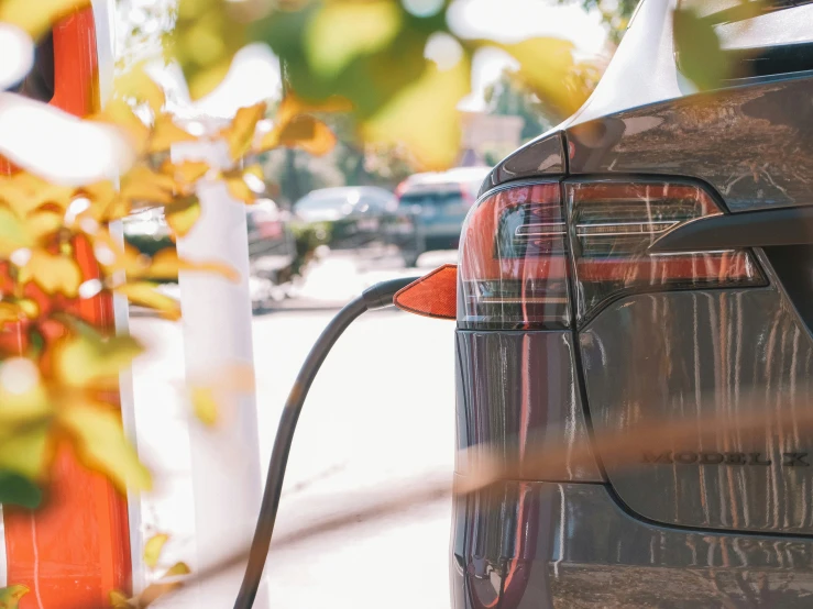 a close up of a car at a charging station, pexels contest winner, “ iron bark, instagram post, musk ( 2 0 2 4 ), 1 0 / 1 0