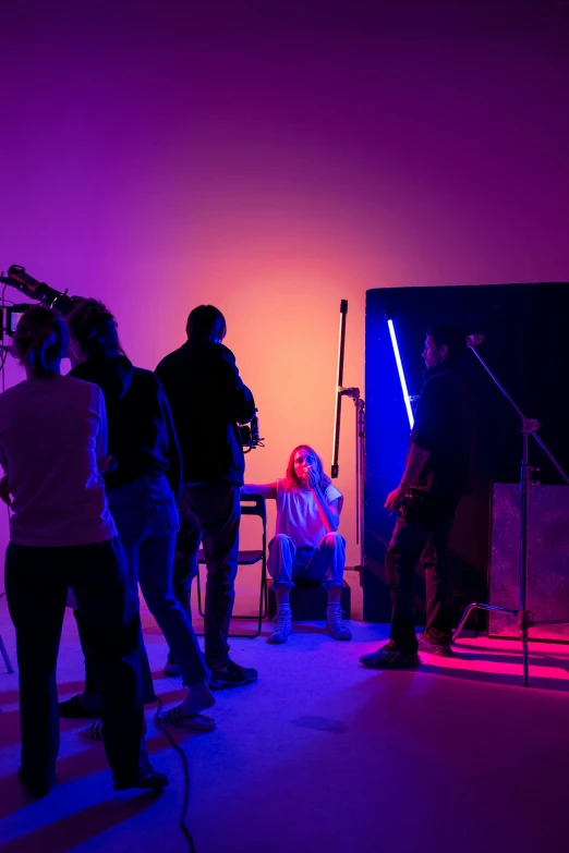 a group of people that are standing in a room, process art, cinematics lighting, pink studio lighting, cinematic blue lighting, shooting