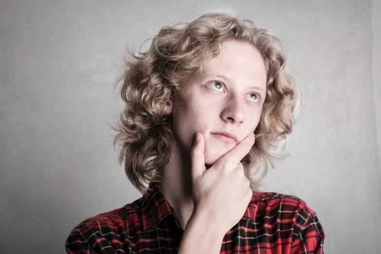 a close up of a person with a hand on their chin, inspired by Anna Füssli, trending on pixabay, curly blond, square masculine jaw, looking confused, wearing a red lumberjack shirt