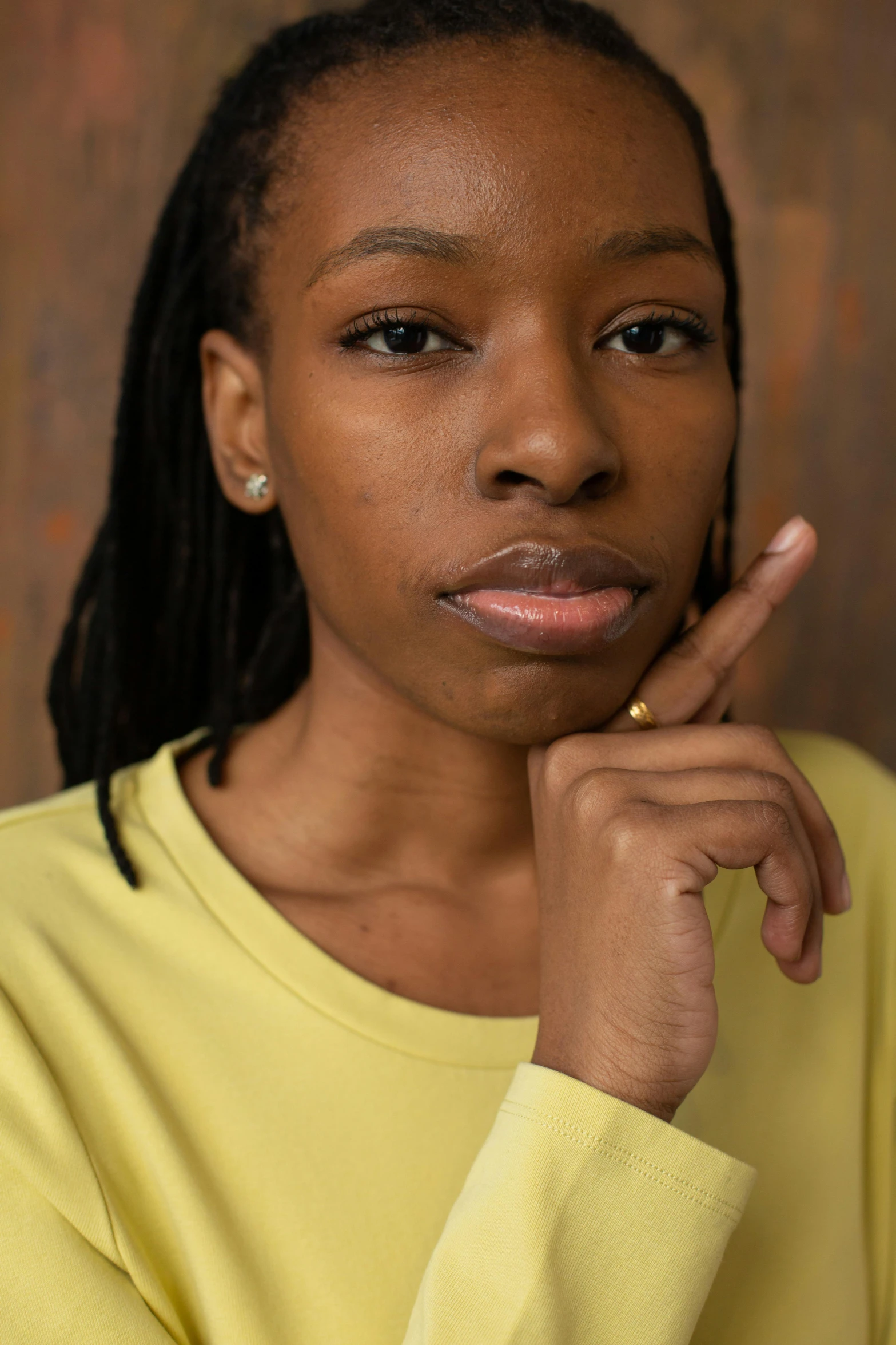 a woman in a yellow shirt posing for a picture, by Lily Delissa Joseph, pouting, full frame image, thoughtful ), ( ( dark skin ) )