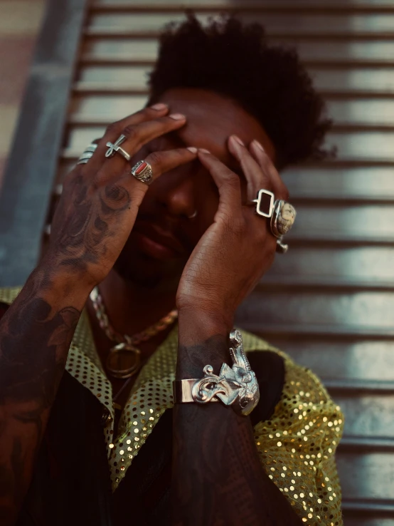 a man with his hands on his face, an album cover, inspired by L. A. Ring, trending on pexels, black jewelry, waist - shot, very very low quality picture, 2 1 savage