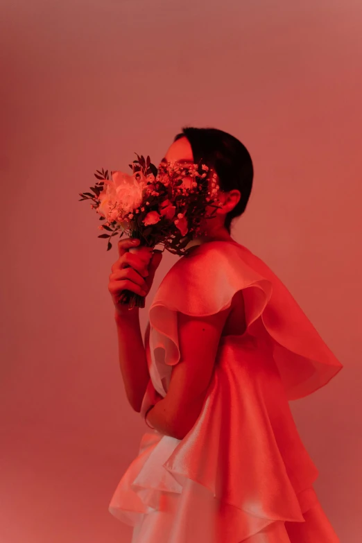 a woman in a red dress holding flowers, an album cover, inspired by Gao Cen, unsplash, romanticism, nick knight, ignant, wedding, coral