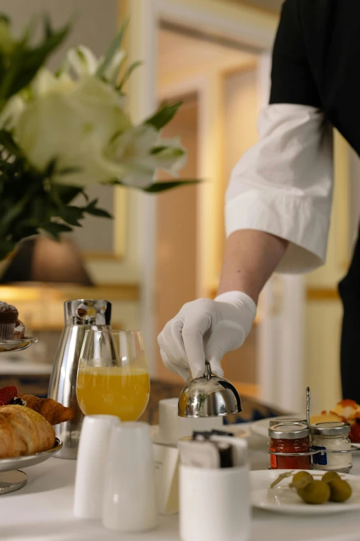 a person in white gloves serving food on a table, breakfast, paris hotel style, superior, up close