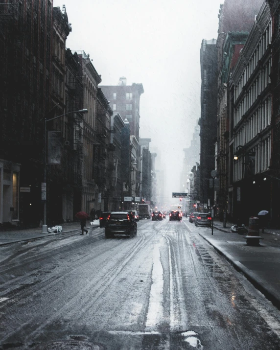 a street filled with lots of traffic next to tall buildings, inspired by Elsa Bleda, pexels contest winner, in an ice storm, lgbtq, gray concrete, gif