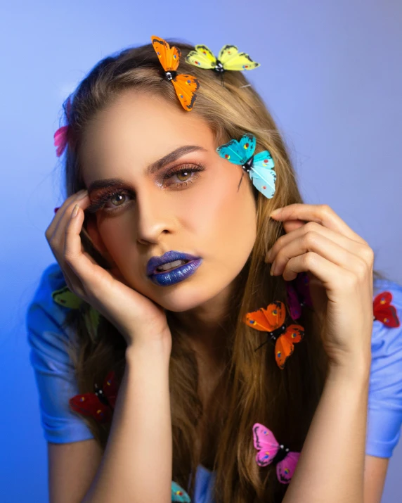 a beautiful young woman with colorful butterflies in her hair, by Julia Pishtar, trending on pexels, art photography, blue lips, photoshoot for skincare brand, trending on mentalray, glam photo