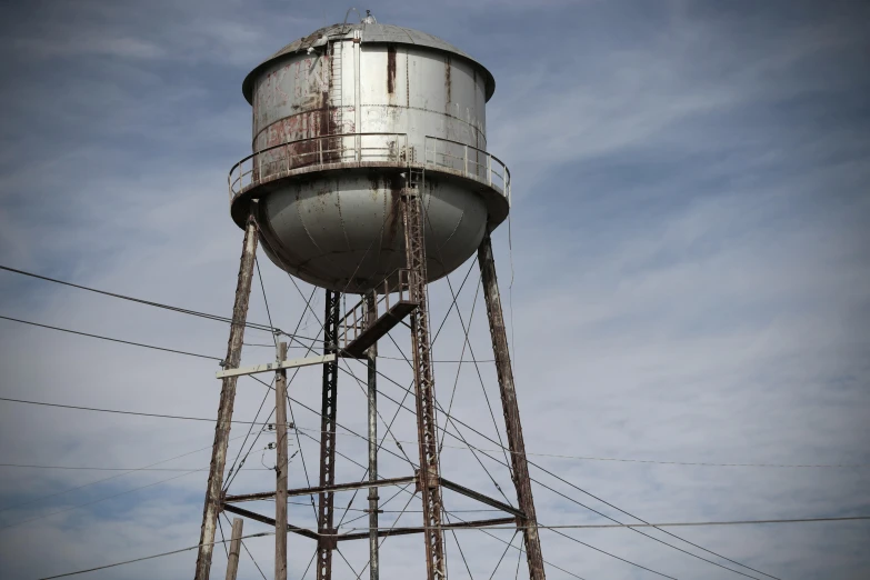 a large metal water tower sitting in the middle of a field, a portrait, unsplash, renaissance, stephen shore, ignant, grungy, vessels