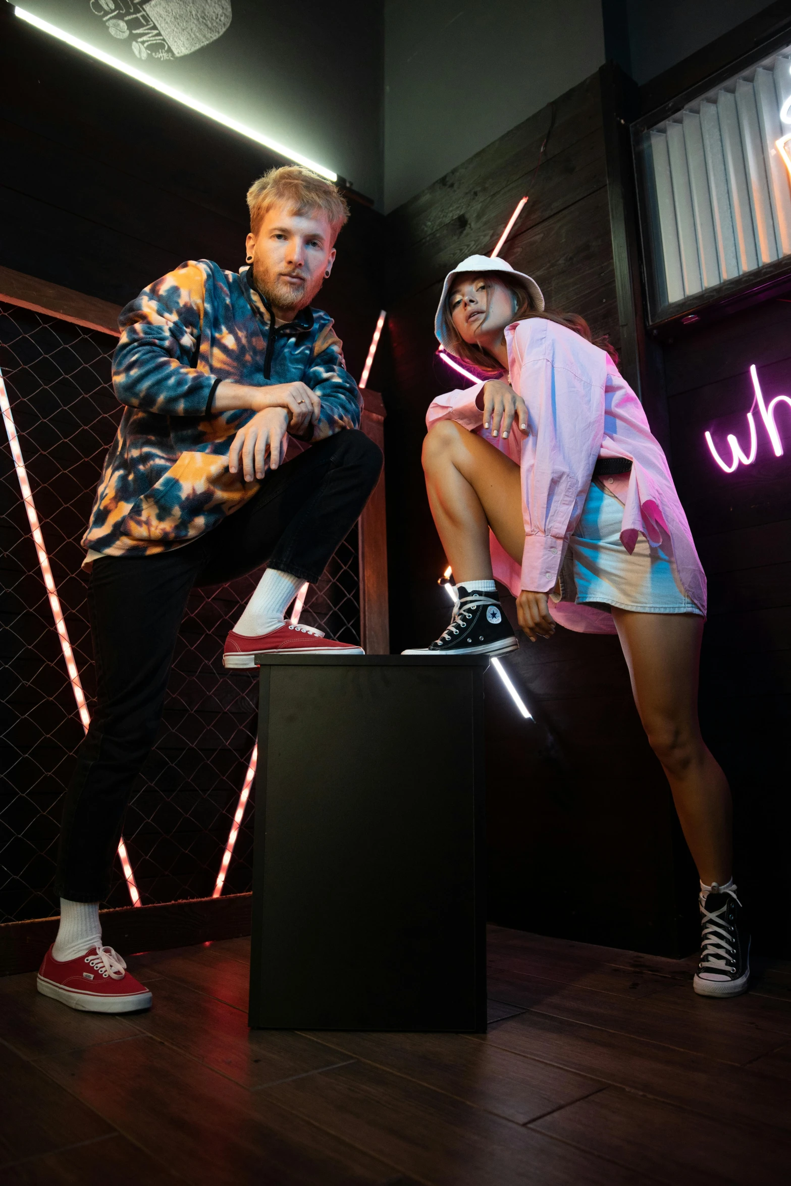 two people sitting on a stool in front of a neon sign, a portrait, trending on pexels, graffiti, wild rave outfit, studio lighting”, focus on sneakers only, standing on top of a piano