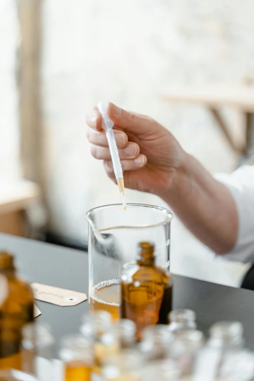 a close up of a person holding a glass of liquid, image apothecary, high samples, thumbnail, brown