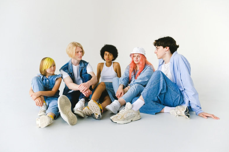 a group of young people sitting next to each other, by Ellen Gallagher, trending on pexels, antipodeans, albino hair, blue jeans. unreal 5, pastel clothing, productphoto