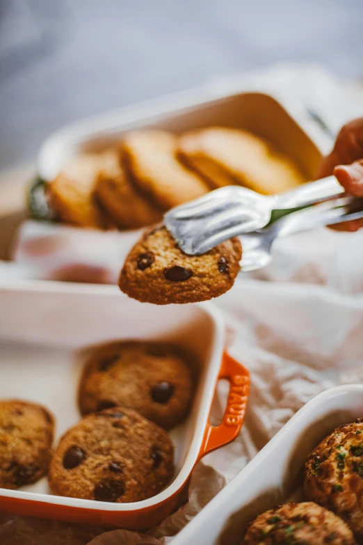 a person taking a bite out of a cookie, a still life, by Andries Stock, trending on pexels, breakfast buffet, 6 pack, radiant soft light, handcrafted