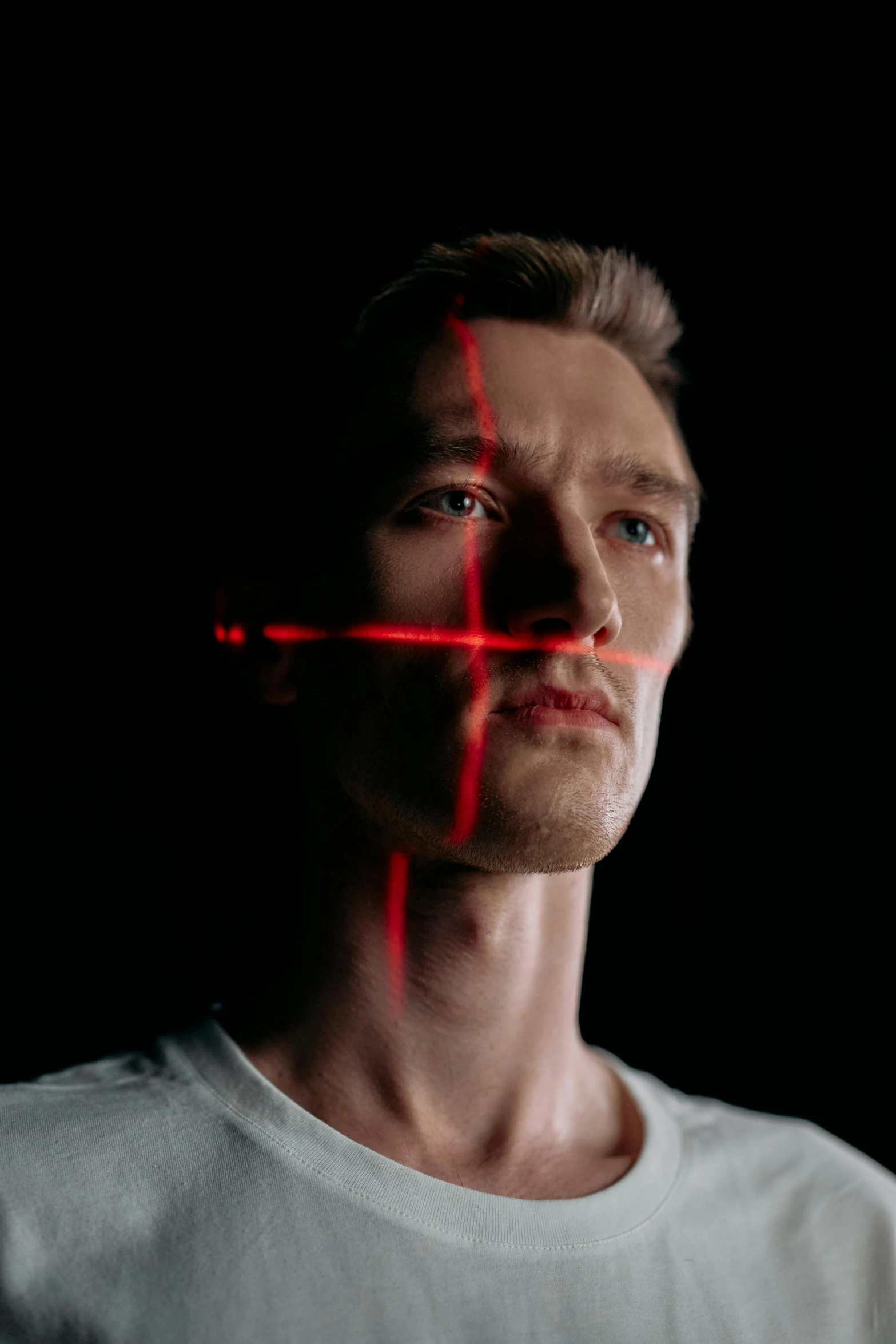 a man with a red cross on his face, a hologram, by Adam Marczyński, reddit, holography, good definition of cheekbones, cinematic framing rule of thirds, square masculine jaw, nvidia promotional image