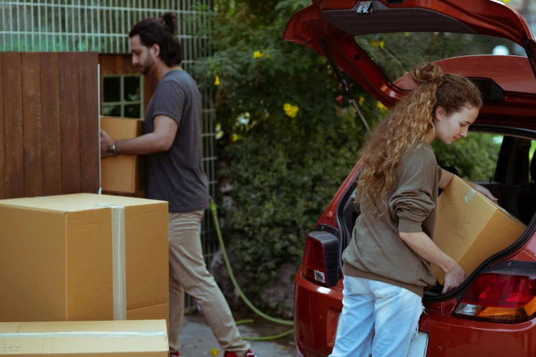 a woman loading boxes into the trunk of a car, pexels contest winner, renaissance, people looking at a house, avatar image, men and women, ad image