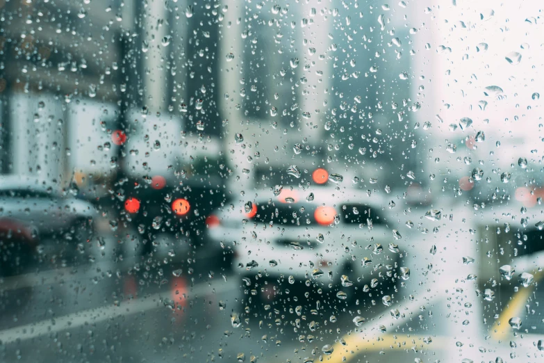 a city street filled with lots of traffic on a rainy day, a picture, inspired by Elsa Bleda, trending on unsplash, visual art, background image, water drops, inside of a car, close - up photo