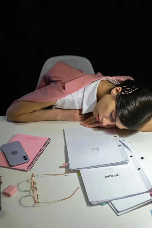 a woman sleeping on top of a desk next to a pile of papers, trending on pexels, hyperrealism, snapchat photo, dua lipa, lights off, cai xukun