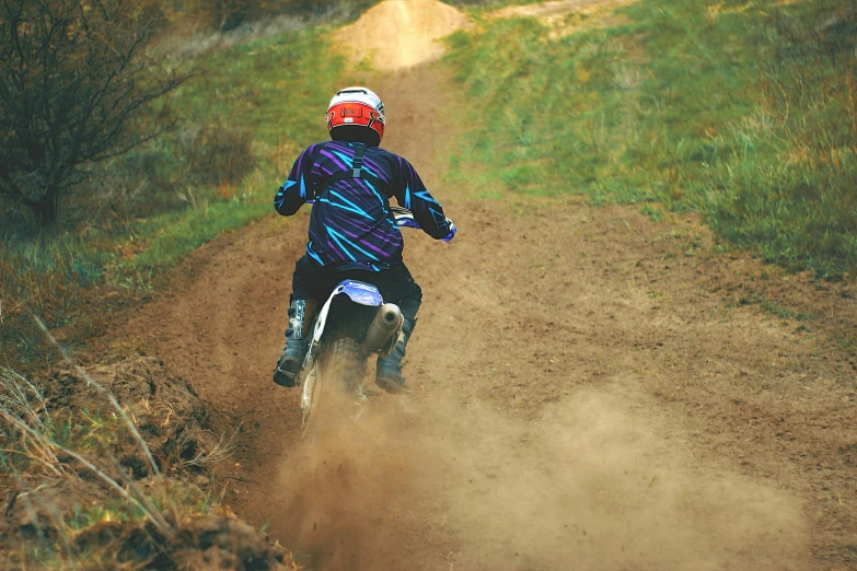 a person riding a dirt bike on a dirt road, profile image, coloured photo, sports clothing, thumbnail