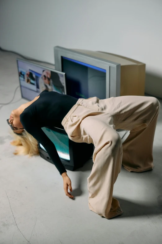 a woman laying on top of a toilet in front of a tv, inspired by Sarah Lucas, trending on pexels, video art, baggy pants, crying fashion model, in front of a computer, modern dance aesthetic