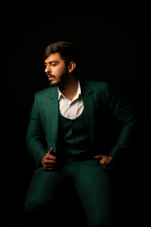 a man in a green suit and white shirt, an album cover, inspired by Saurabh Jethani, pexels contest winner, masculine pose, ( low key light ), ash thorp khyzyl saleem, thicc