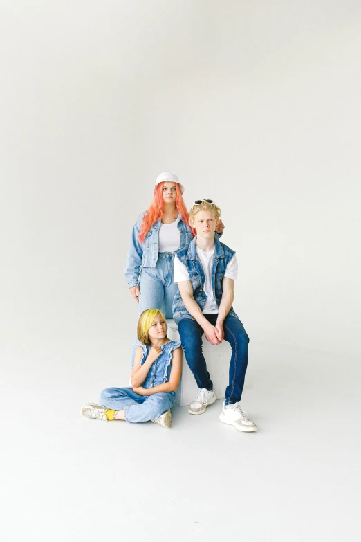 a woman and two children posing for a picture, an album cover, trending on pexels, wearing a jeans jackets, albino hair, light room, each wearing correct era clothes