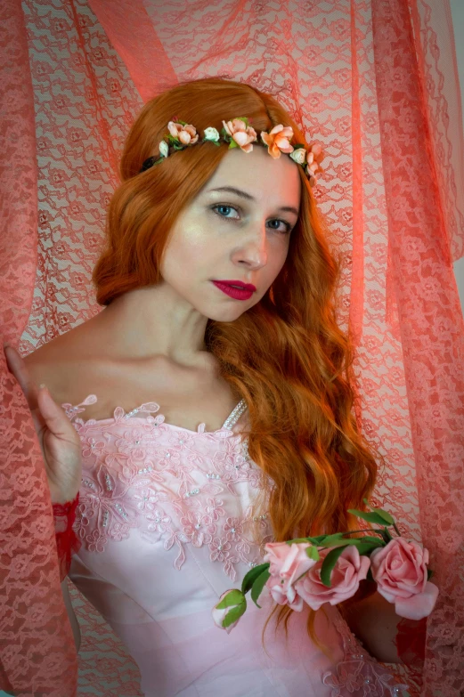 a woman in a pink dress with flowers in her hair, inspired by Konstantin Somov, reddit, long wavy orange hair, 8k octan photo, dressed in a frilly ((lace)), anna nikonova aka newmilky