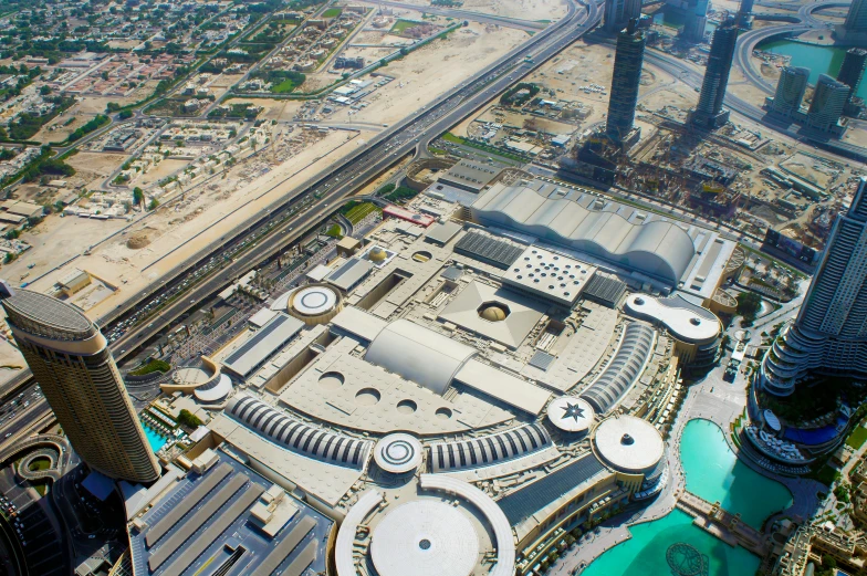 a view of a city from the top of a building, pexels contest winner, renaissance, sheikh mohammed ruler of dubai, on a futuristic shopping mall, infinity concentric pool, satellite view