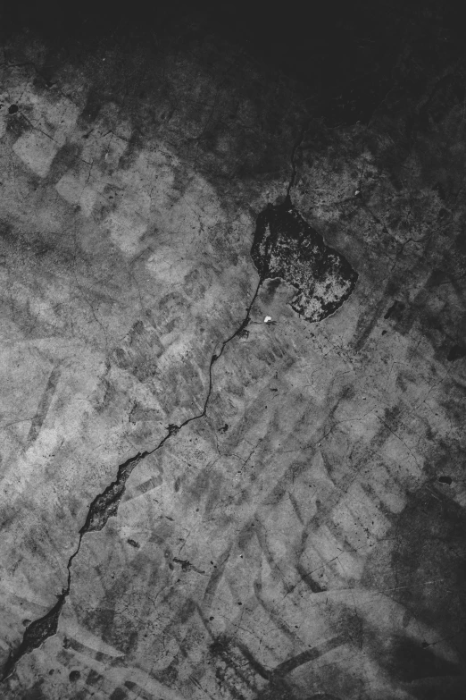 a black and white photo of a cracked wall, an album cover, satellite view, ffffound, in a basement, 16k upscaled image