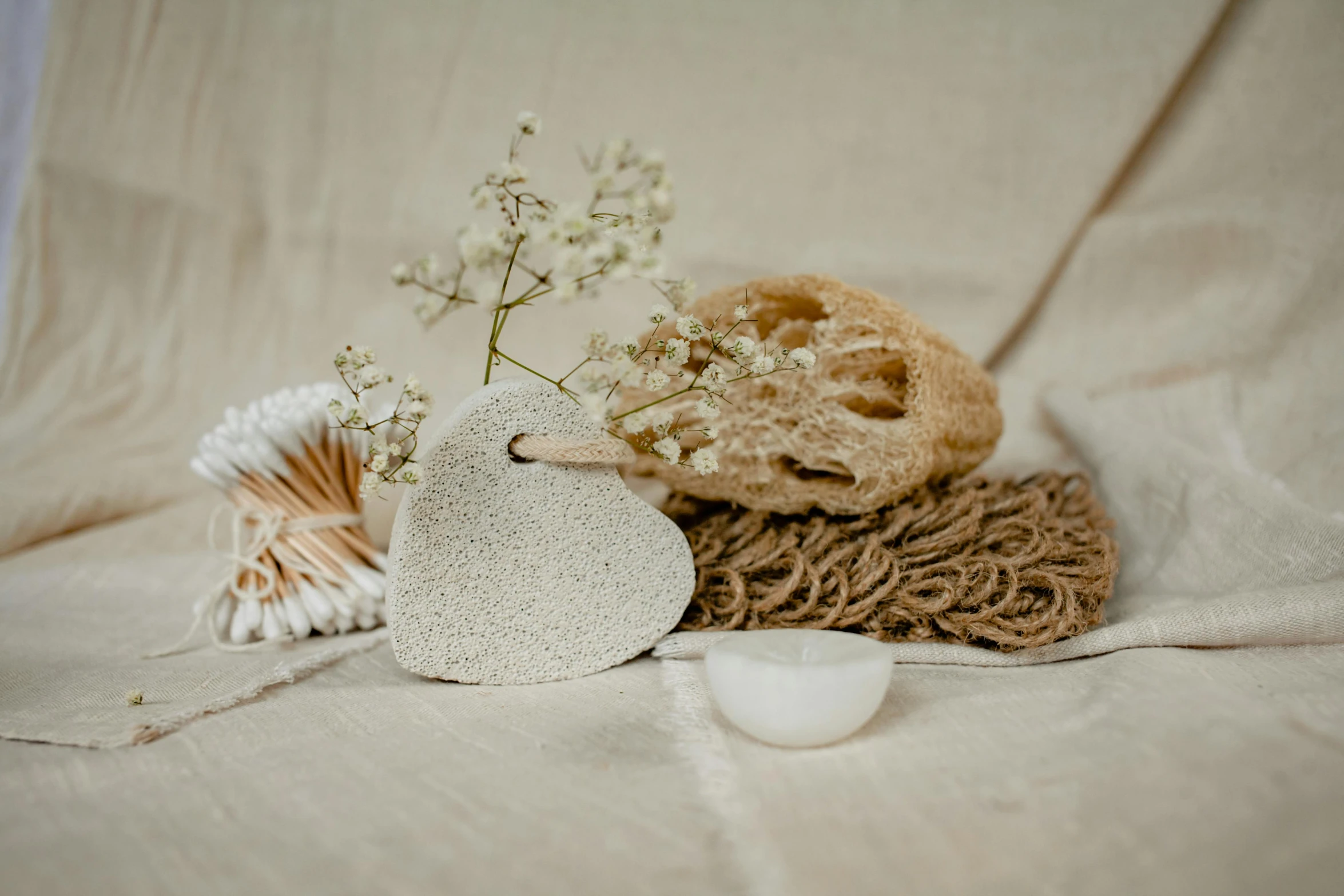 a bunch of items sitting on top of a bed, by Sylvia Wishart, trending on pexels, sand particles, white clay, rustic, flower decorations