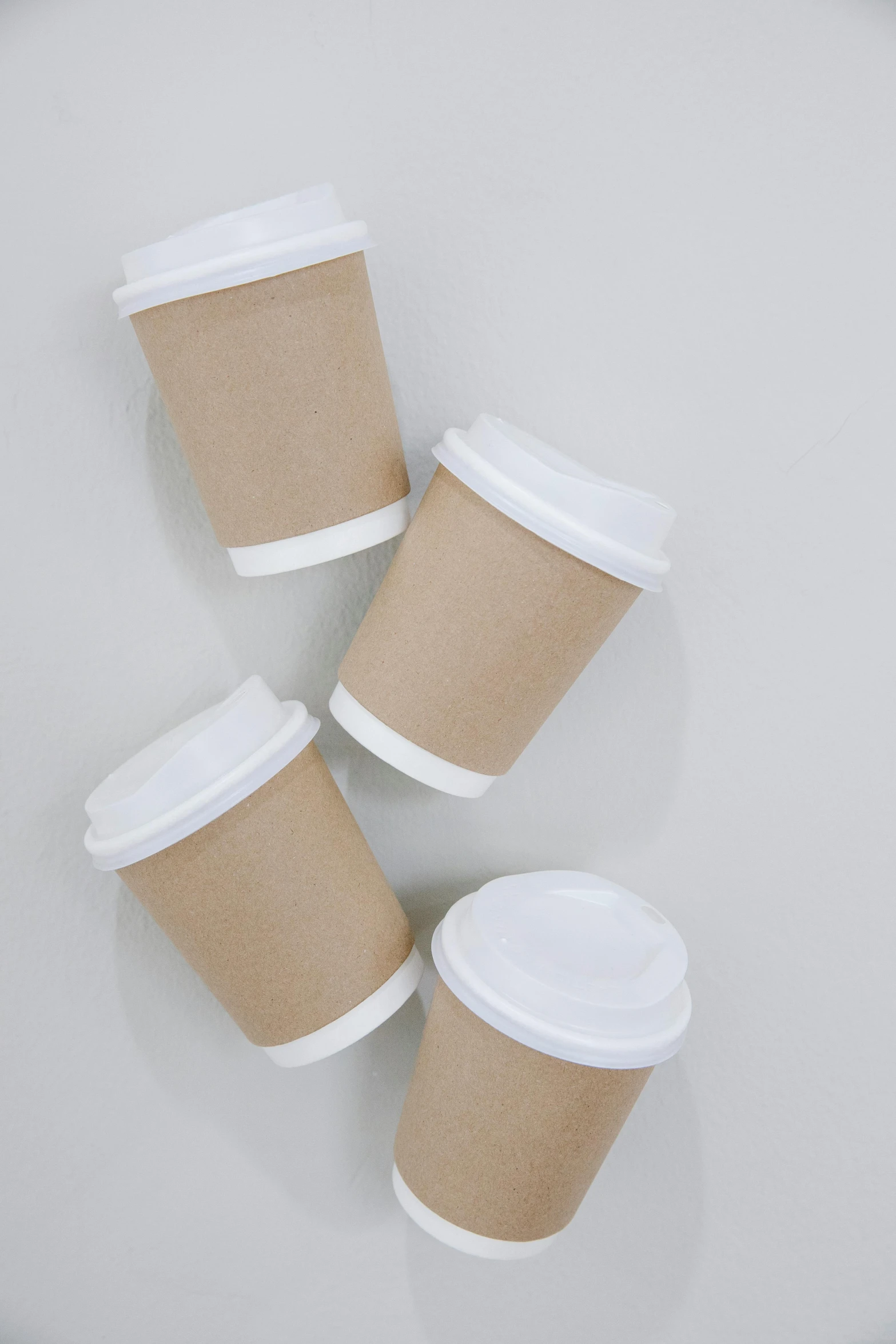 three cups of coffee sitting on top of a table, by Jessie Algie, unsplash, minimalism, paper cup, tan, 15081959 21121991 01012000 4k, packaging