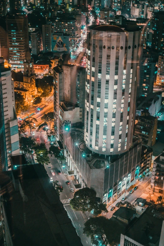 an aerial view of a city at night, by Felipe Seade, happening, tall building, brazil, instagram post, low detail