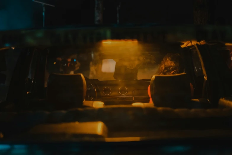 a car driving down a street at night, inspired by Elsa Bleda, pexels contest winner, sitting at a bar, avatar image, cinematic closeup, faded and dusty