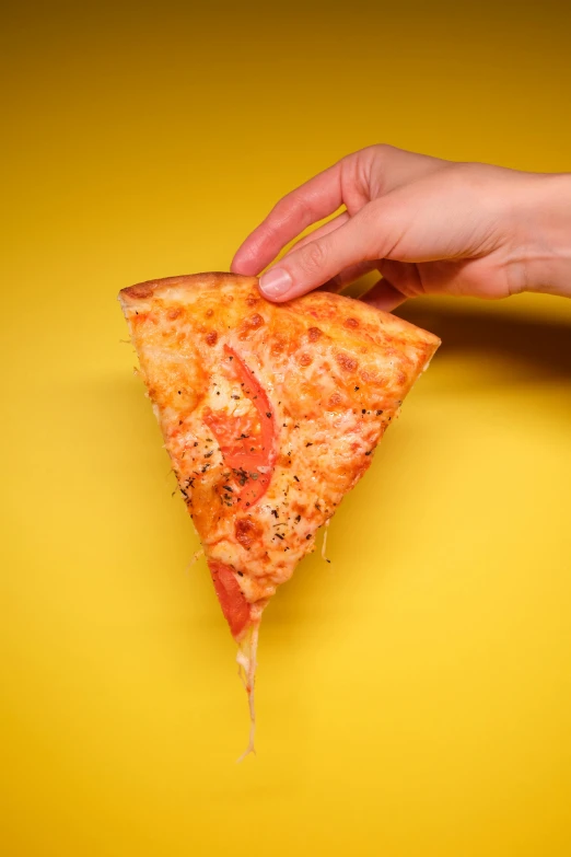 a person holding a slice of pizza in their hand, pexels, photorealism, on yellow paper, triangle, dramatic product shot, gooey skin