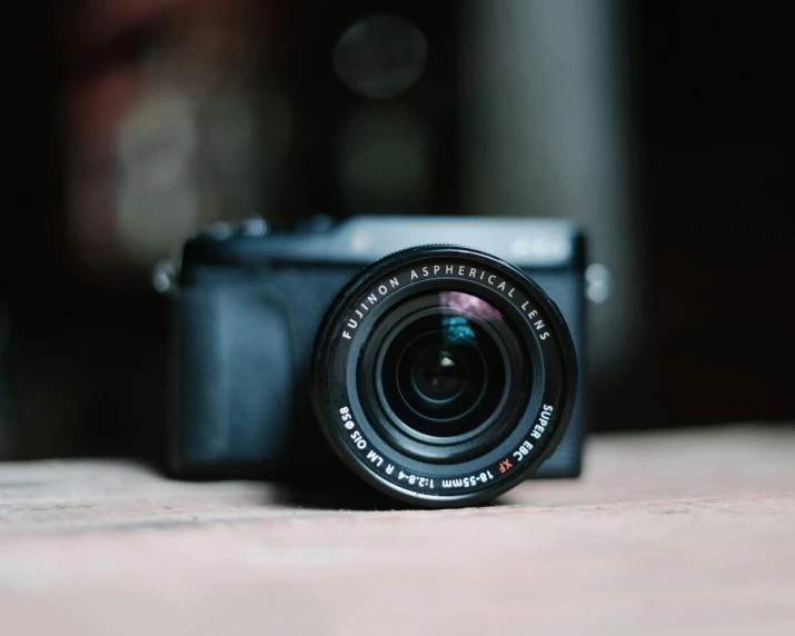 a camera sitting on top of a wooden table, by Rupert Shephard, pexels contest winner, lens zooming, today\'s featured photograph 4k, portrait of a small