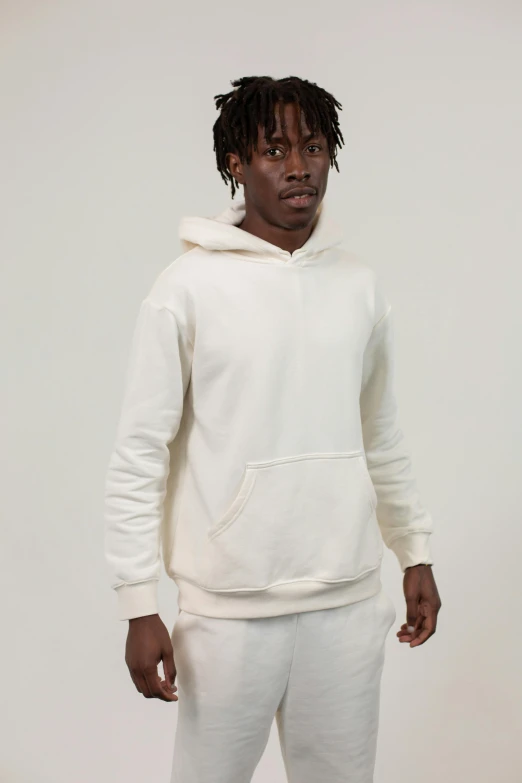 a man in a white hoodie standing in front of a white wall, yzy gap, ivory, background image, thumbnail