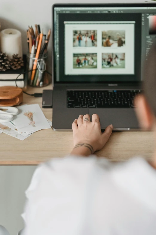 a man sitting at a desk using a laptop computer, a picture, by Nicolette Macnamara, trending on pexels, long shot view, photo of young woman, everything fits on the screen, half body cropping