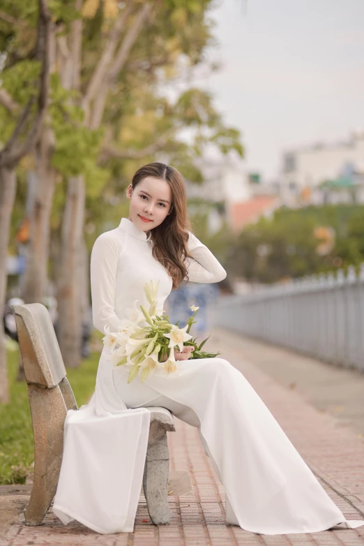 a woman in a white dress sitting on a bench, ao dai, trending on imagestation, white pants, square