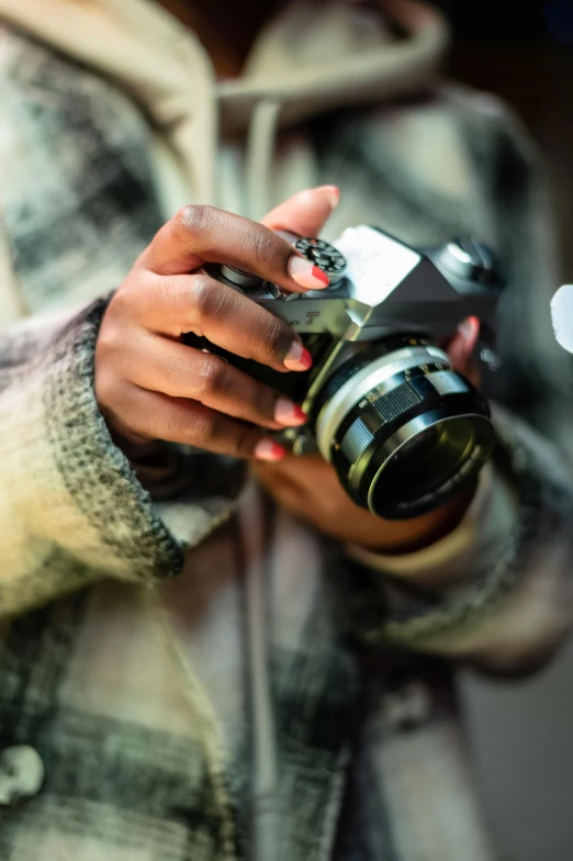 a close up of a person holding a camera, inspired by Gordon Parks, photography”